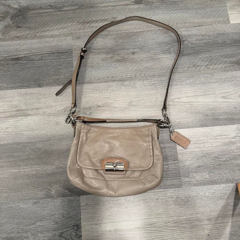 Coach Kristin leather hobo bag featuring a distinctive silver-tone turnlock